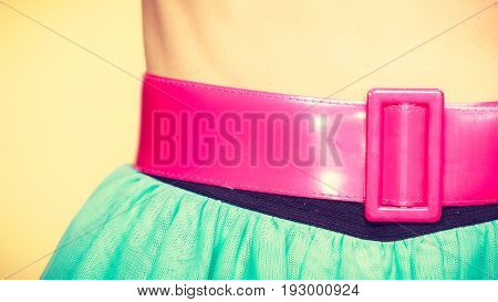 Woman fahion accessories clothing concept. Close up of pink belt on blue turquoise tulle skirt