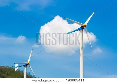eco power : wind turbines generating electricity clean energy with cloud on blue sky background