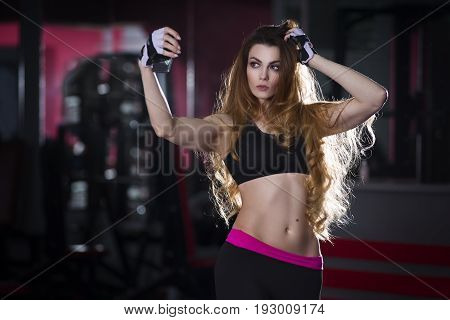 Young sexy fitness girl doing selfie in gym woman with perfect muscular body and long hair