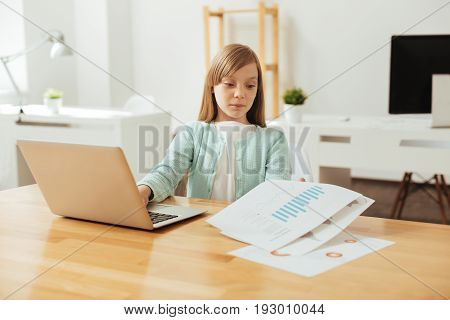 Diligent lady. Intelligent persistent dedicated child studying data while using computer for searching and arraigning needed information