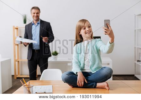 I got you. Pretty sincere inspired girl sending mom a message and telling her about the day at dads office while making a selfie
