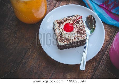tasty chocolate cherry cake dessert on wood table and copy space