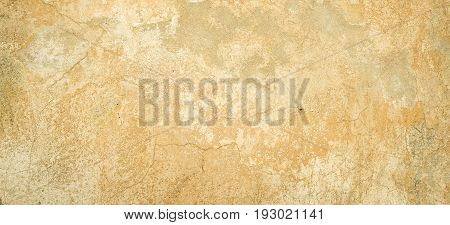 Old vintage grungy plaster beige painted wall texture background