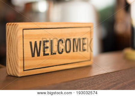 Welcome sign on the counter shop business concept.