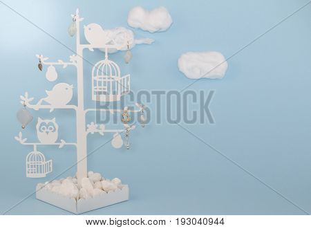 Baby boy blue background invitation with cottonwool clouds and bird trinket tree