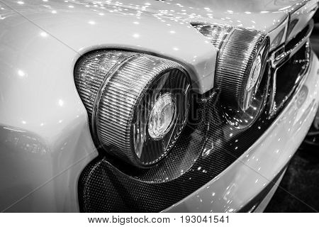 MAASTRICHT NETHERLANDS - JANUARY 15 2016: Stoplight of a sports car Ferrari F430 close-up 2006. Black and white. International Exhibition InterClassics & Topmobiel 2016
