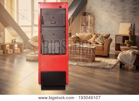Energy savings concept. Solid fuel boiler in living room 