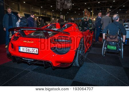 MAASTRICHT NETHERLANDS - JANUARY 15 2016: Hypercar Porsche 918 Spyder. Rear view. International Exhibition InterClassics & Topmobiel 2016
