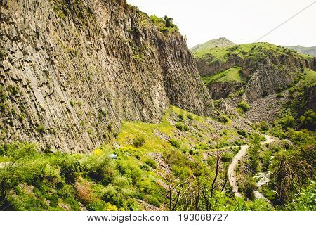 Mountain valley landscape with unique geological formation called Symphony of Stones. Basalt rock. Ecotourism. Nature background. Adventure holiday. Armenia, Garni. Travel vacation. Climbing tourism