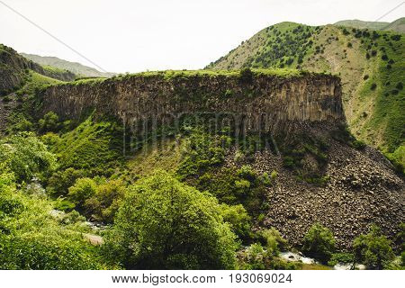 Mountain landscape with amazing geological formation Basalt rock. Ecotourism. Nature background. Adventure holiday. Armenia, Garni. Travel vacation. Climbing tourism. Beauty world. Ecology concept