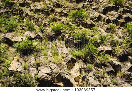 Mountain unique geological formation called Symphony of Stones. Basalt rock. Ecotourism. Nature background. Adventure holiday. Armenia, Garni. Travel vacation. Climbing tourism concept. Stone texture