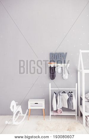 The word baby on a gray background. Inscription toddler. Detail of the interior of the children's room. Children bedroom.
