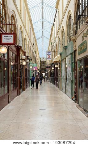 PARIS, FRANCE - June 08, 2017: Interior of Passage Choiseul - shopping area with clothing stores, book stores, jewelers shops and art galleries.