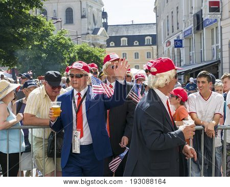 LE MANS, FRANCE - JUNE 16, 2017: Men in the parade of pilots in Le Mans with beer disguised as Donald Trump