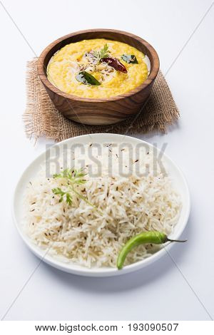 Indian popular food Dal fry or traditional Dal Tadka Curry served with jeera rice, isolated over white background, selective focus