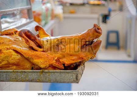 Delicious hornado roasted pork, over a silver tray, ecuadorian traditional typical andean food located in the municipal market in San Francisco in the city of Quito.