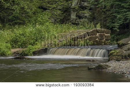 Dolsky mill in national park with old ruin of mill in north Bohemia