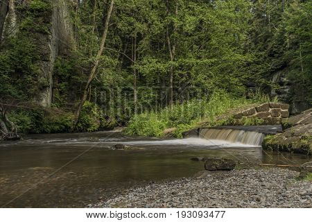 Dolsky mill in national park with old ruin of mill in north Bohemia