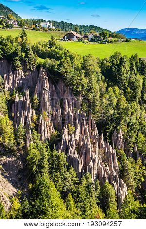 The charming small village in the Dolomites. Wonderful Tirol, Italy. Renon's earth pillars at sunrise. The concept of ecological tourism