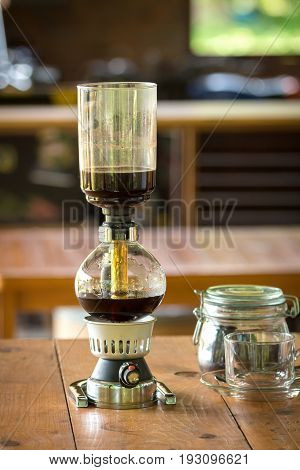 Close Up Of Siphon Vacuum, Coffee Cup And Siphon Vacuum Coffee Maker At Shop