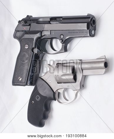 A black semi automatic pistol with a stainless revolver
