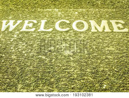 Welcome on dark green texture background floor mat