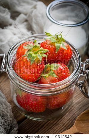 Strawberry In Jar On Wooden Background.
