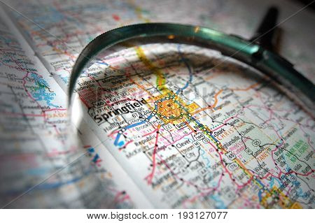 A magnifying glass over a map of Springfield, Missouri.