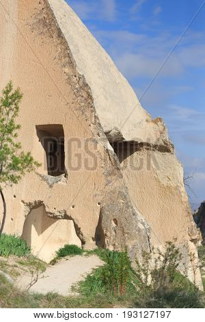 Vertical Shot Of Cave Church In Cappadocia Shot On Sunny Day With Blue Sky
