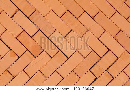 herring -bone pattern on a basement with red bricks