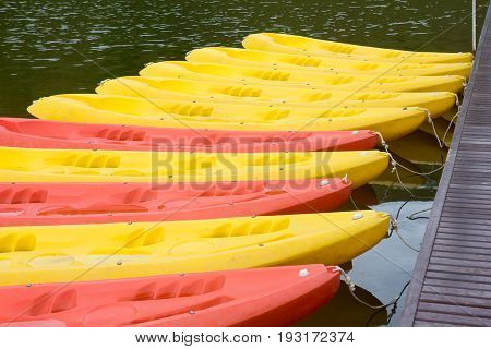 Group of red yellow color Kayak stop at the port