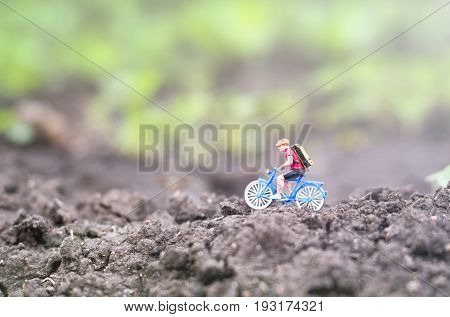 A toy cyclist is taking a ride. Ecotourism concept.