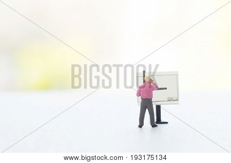 A conceptual photo with a toy engineer or other professional  at the empty drawing board with a place for your text. Focus on a figurine of a human.