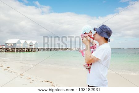 Father and daughter playing at the beach at the day time.