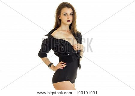 Charming young girl take off a jacket without bra under it and looking at the camera isolated on white background