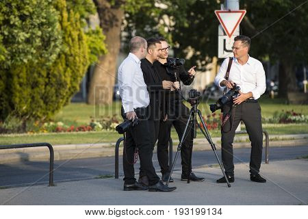 BUDAPEST, HUNGARY. 23 JUNE, 2017: A group of wedding photographers on the streets of Budapest is holding a photo session for a couple of newlyweds.