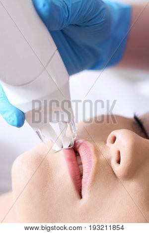 Endermologie. Vacuum mouth enlargement Woman in the clinic of aesthetic medicine.