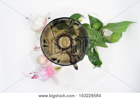 black glass small Cup on a white Lacy napkin on a white background