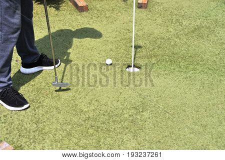 Boy Playing In Minigolf