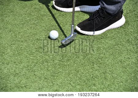 Boy Playing In Minigolf