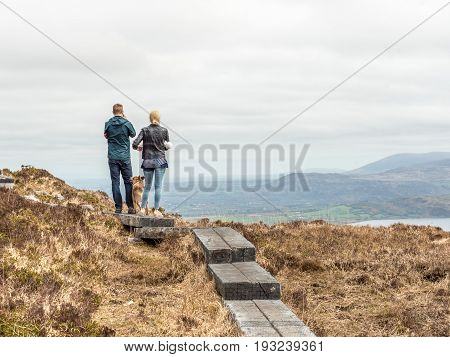 Man, Dog, And Woman On Torc Mountain