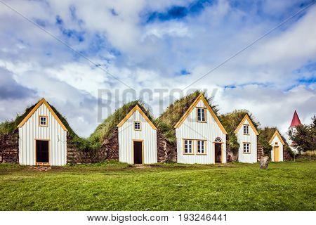 The picturesque village of old houses covered with turf and grass. Ethnographic Museum-estate Glaumbaer, Iceland. The concept of the historical and cultural tourism