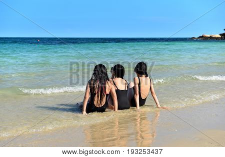 Young Weman Sit And Relaxing On The Beach