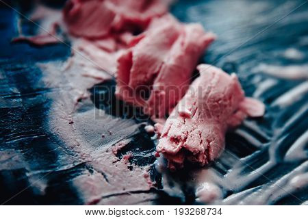 Ice cream roll fried in the fridge freezer pan on the street in Thailand fresh cooking made from fresh strawberries milk blueberries. Concept of tourist delicacy.