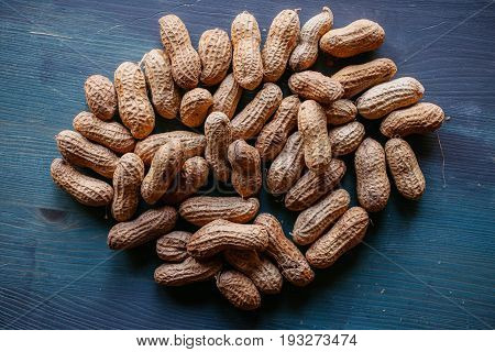 Peanut in shell texture and background. Peanuts texture. Shelled Peanuts. Healthy food. Close up view of shelled peanuts in wooden background. Abstract background and texture for designers.