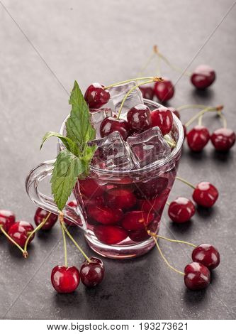 Ice cream and cherry juice on black stone board
