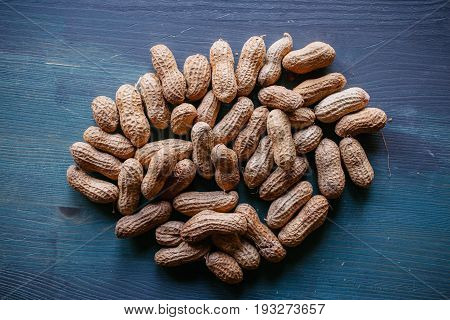 Peanut in shell texture and background. Peanuts texture. Shelled Peanuts. Healthy food. Close up view of shelled peanuts in wooden background. Abstract background and texture for designers.