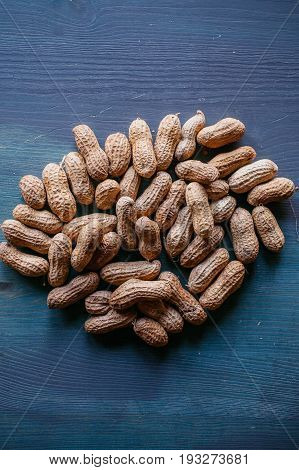 Peanut in shell texture and background. Peanuts texture. Shelled Peanuts. Healthy food. Close up view of shelled peanuts in wooden background. Abstract background and texture for designers.