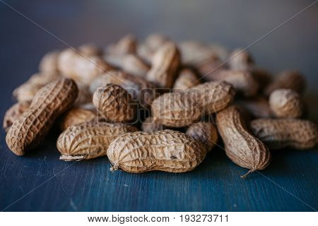 Peanut in shell texture and background. Peanuts texture. Shelled Peanuts. Healthy food. Close up view of shelled peanuts in wooden background. Abstract background and texture for designers.