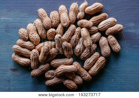 Peanut in shell texture and background. Peanuts texture. Shelled Peanuts. Healthy food. Close up view of shelled peanuts in wooden background. Abstract background and texture for designers.